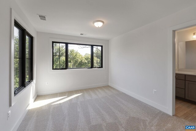 empty room featuring light colored carpet