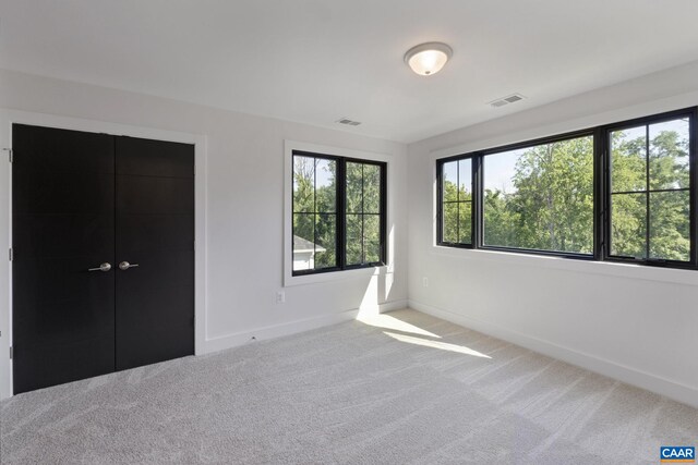 unfurnished bedroom with carpet floors and a closet