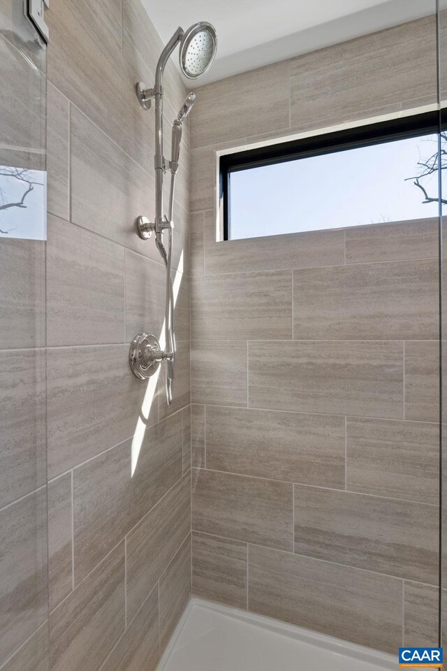 bathroom with a tile shower