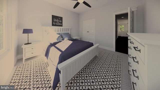 bedroom featuring light colored carpet, ceiling fan, and a closet