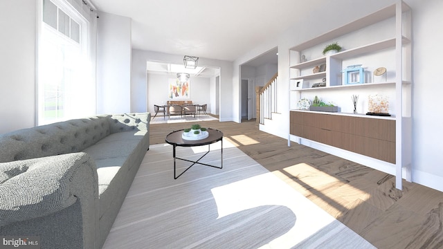 living room featuring light hardwood / wood-style floors and built in shelves