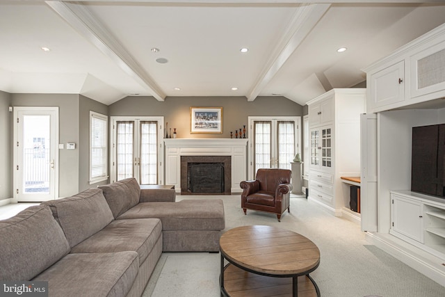 carpeted living room featuring french doors and lofted ceiling with beams