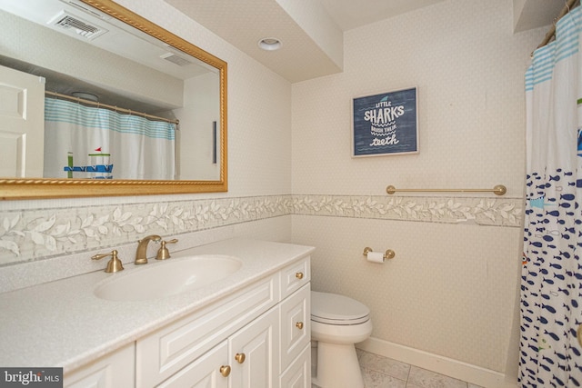 bathroom featuring vanity, tile patterned floors, and toilet