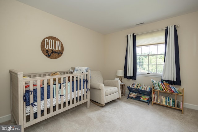 carpeted bedroom with a nursery area