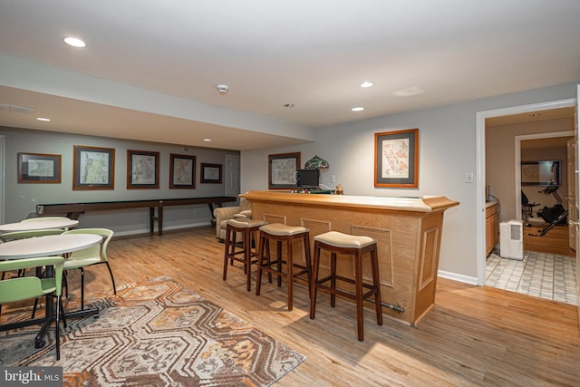 bar with light wood-type flooring