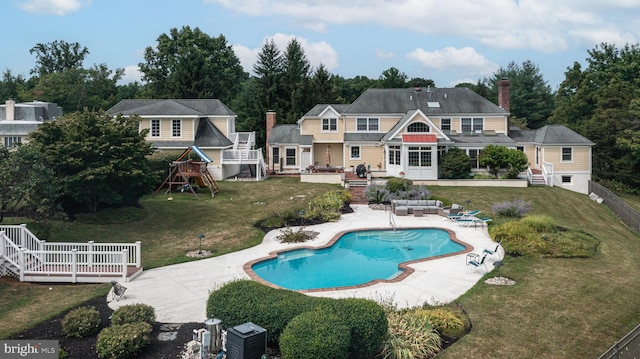 view of swimming pool with a playground, a patio, an outdoor living space, and a lawn