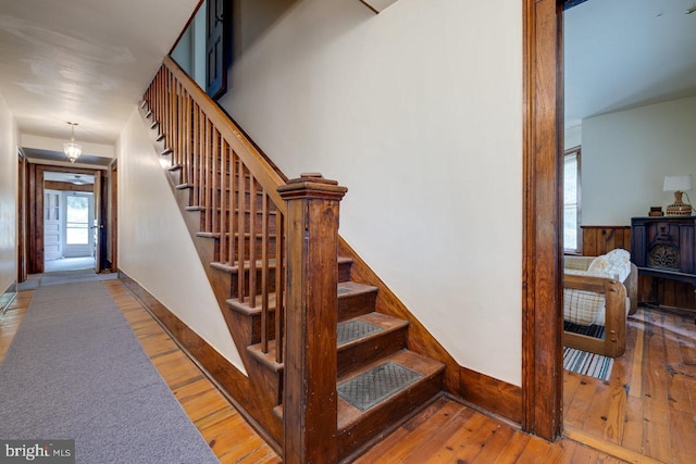 staircase with hardwood / wood-style flooring