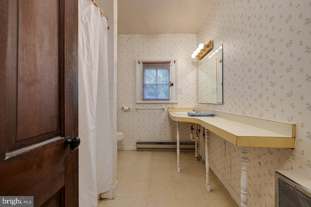 bathroom featuring baseboard heating and toilet