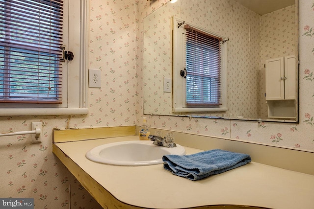 bathroom featuring a healthy amount of sunlight and vanity