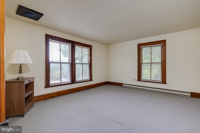 unfurnished room with a baseboard radiator and light colored carpet