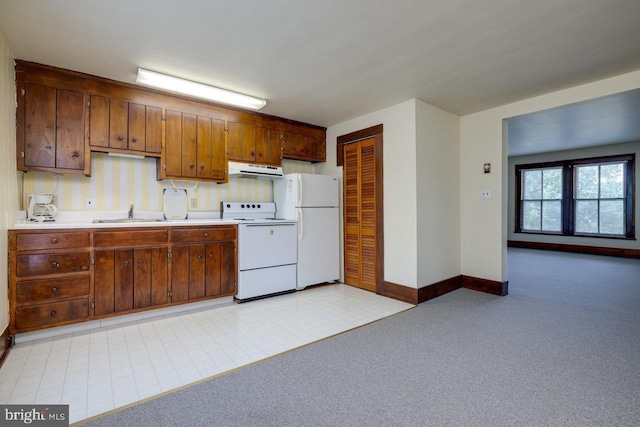 kitchen with white appliances, sink, and light colored carpet