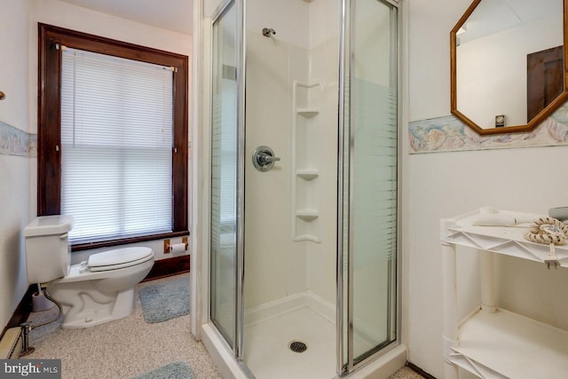 bathroom with toilet and a shower with shower door