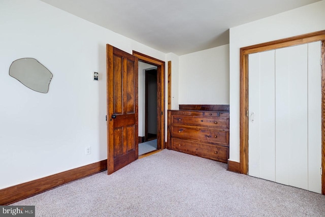 bedroom featuring light carpet and a closet