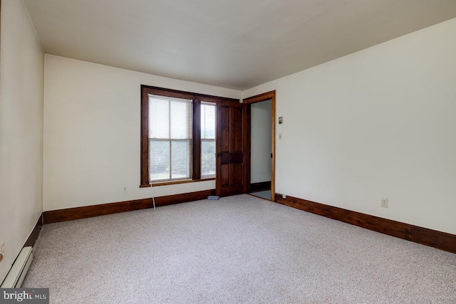 carpeted spare room featuring a baseboard radiator