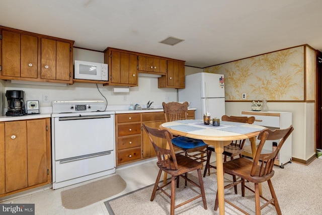 kitchen featuring white appliances and sink