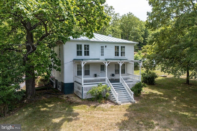 view of front of house featuring a front yard and covered porch