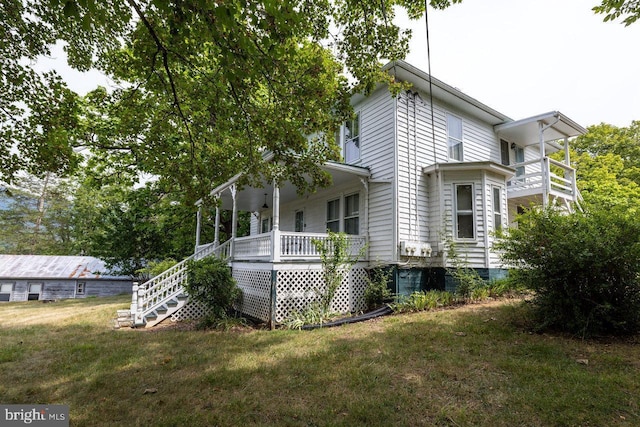 view of home's exterior with a porch and a yard