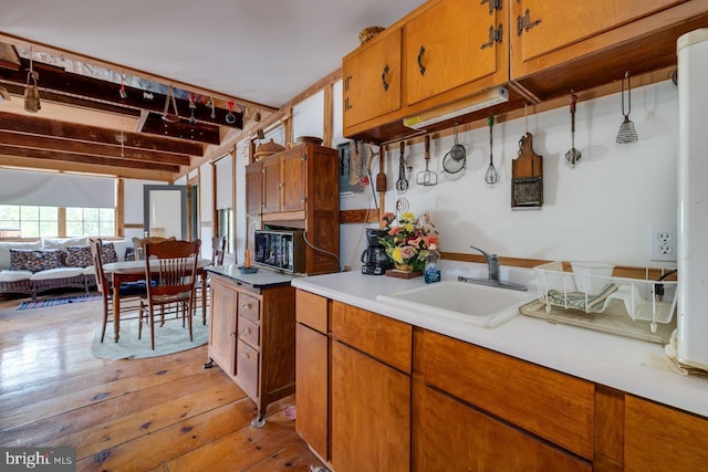 kitchen with sink and light hardwood / wood-style flooring