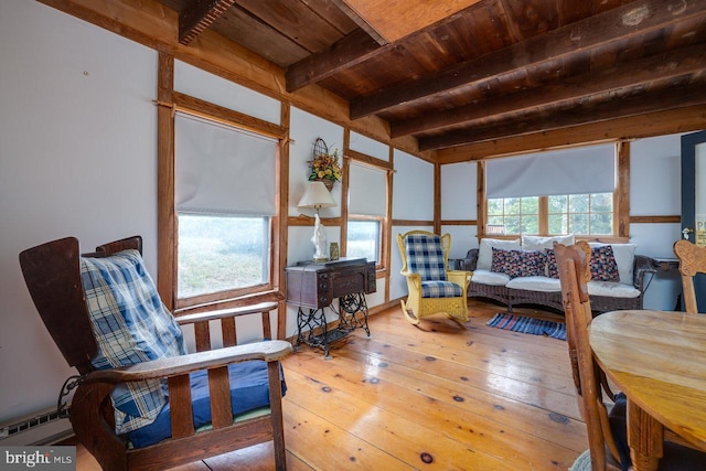 sunroom with wood ceiling, a baseboard heating unit, and beamed ceiling