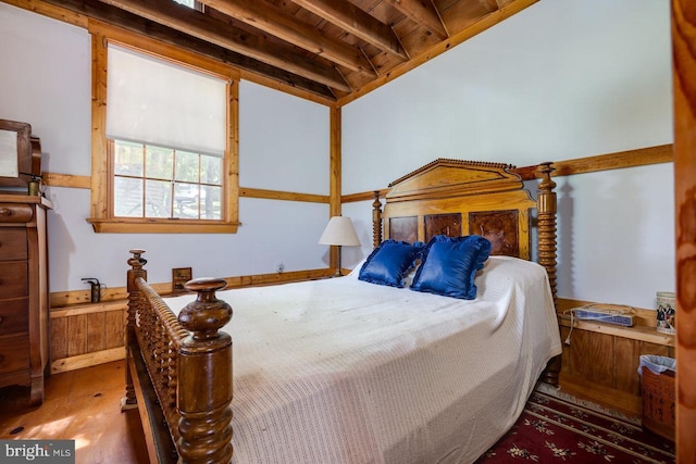 bedroom with beamed ceiling and wood ceiling