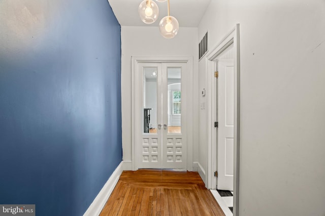 hallway with hardwood / wood-style floors