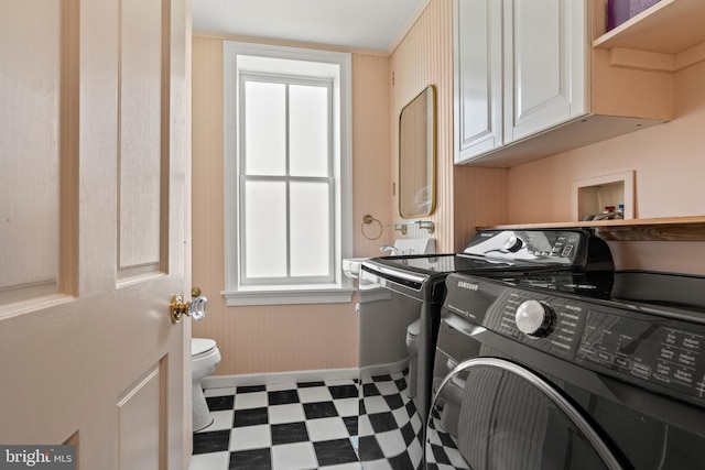 clothes washing area with independent washer and dryer and tile patterned floors