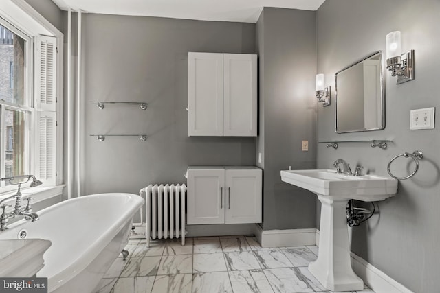 bathroom with a tub, tile patterned floors, and radiator