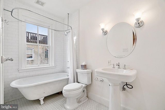 bathroom featuring tile patterned flooring and toilet