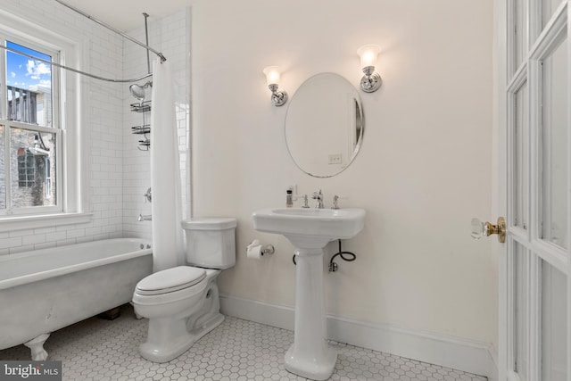 bathroom with toilet, shower / bathtub combination with curtain, and tile patterned floors