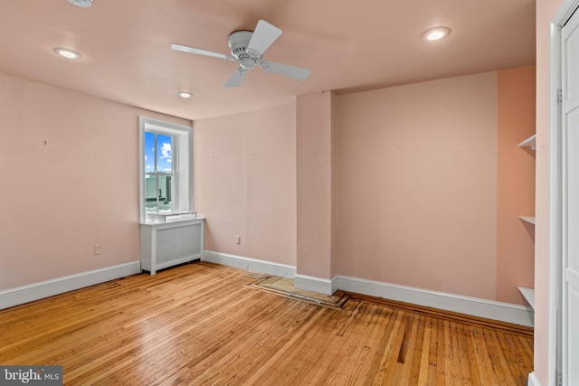 empty room featuring ceiling fan and light hardwood / wood-style floors