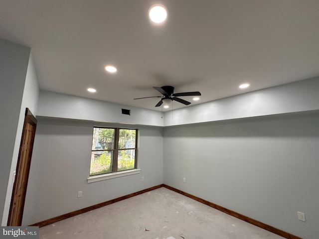 spare room featuring concrete floors and ceiling fan