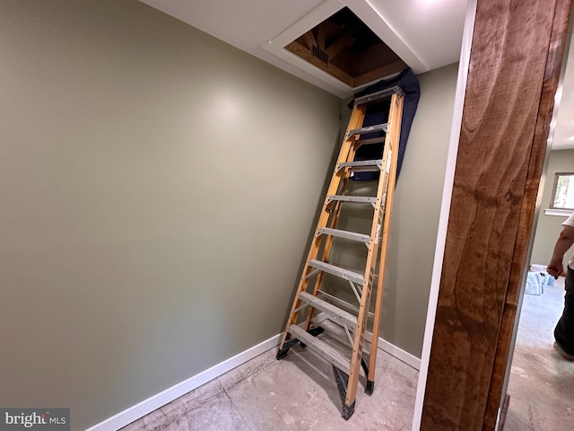 staircase with concrete floors