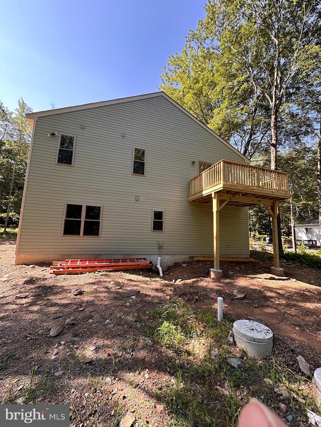 view of side of property featuring a wooden deck