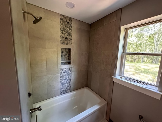 bathroom featuring tiled shower / bath combo and a wealth of natural light