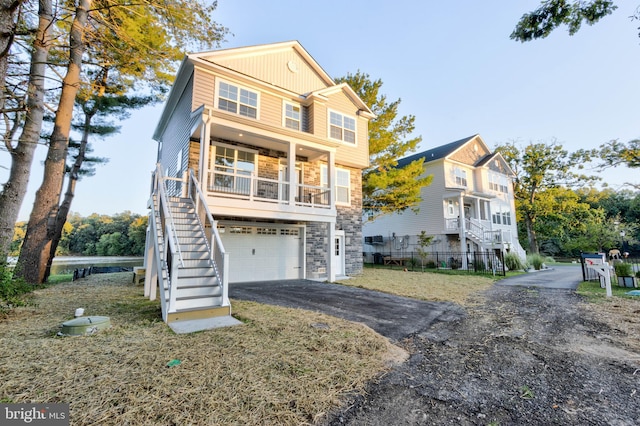 view of property with a garage and a porch