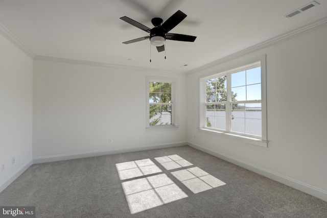 carpeted spare room with crown molding and ceiling fan