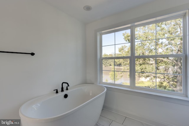 bathroom with a tub to relax in