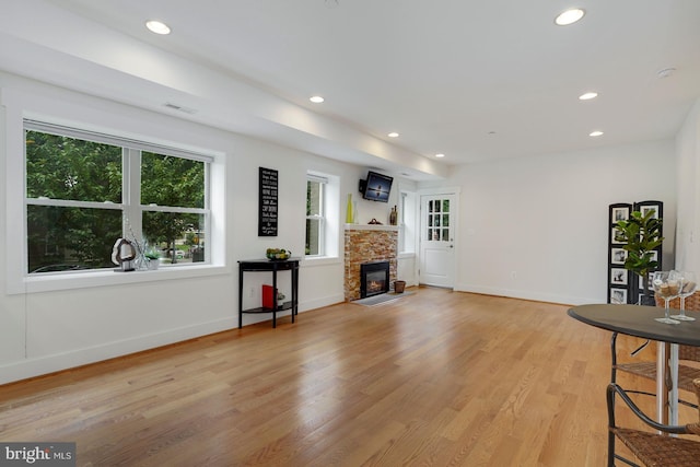 living room with a fireplace and light hardwood / wood-style floors