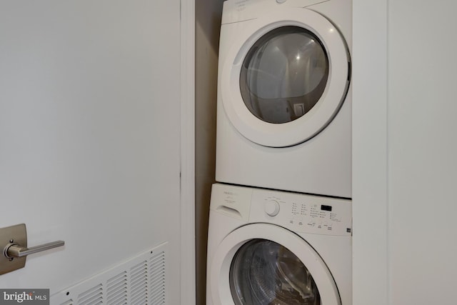 laundry area with stacked washing maching and dryer