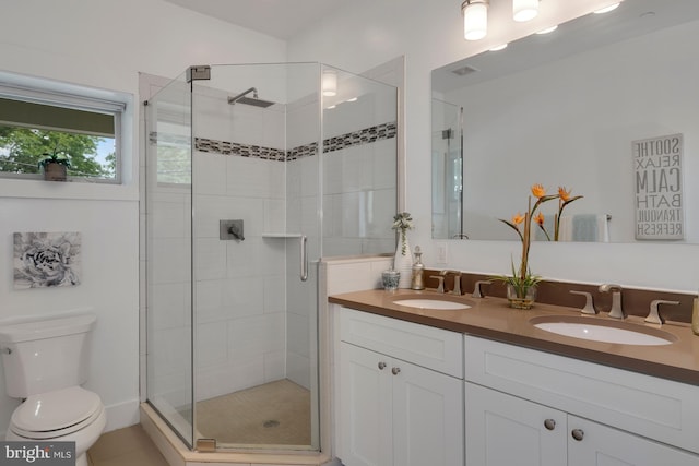 bathroom with vanity, an enclosed shower, and toilet