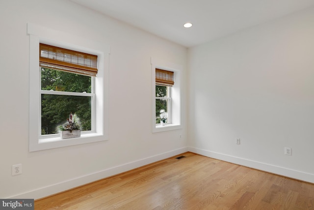 unfurnished room with light wood-type flooring