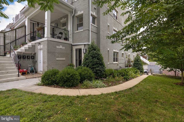 view of side of home with a lawn