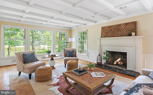 living room with coffered ceiling, beamed ceiling, and light wood-type flooring