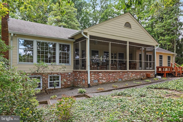 back of house featuring a sunroom and ceiling fan