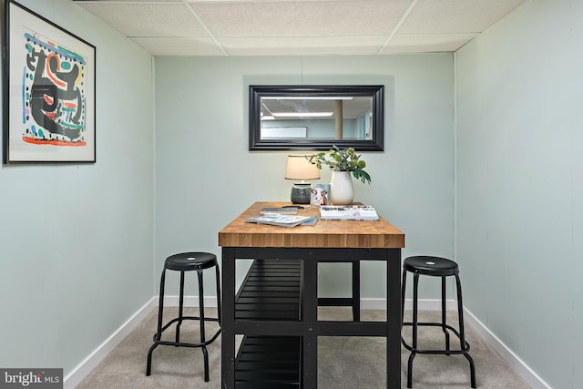 dining room featuring a paneled ceiling and carpet