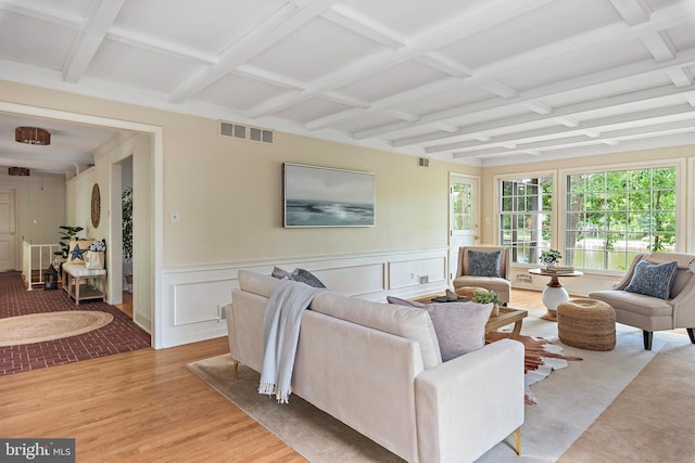 living room with coffered ceiling, beam ceiling, and light hardwood / wood-style flooring