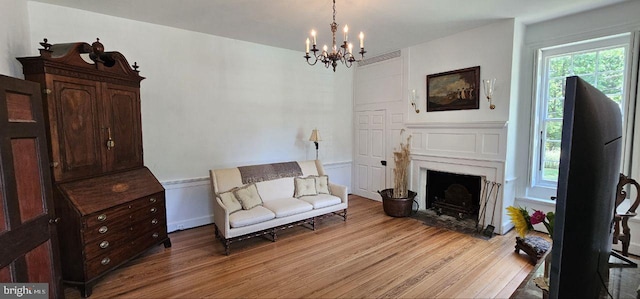 sitting room with a notable chandelier and wood-type flooring