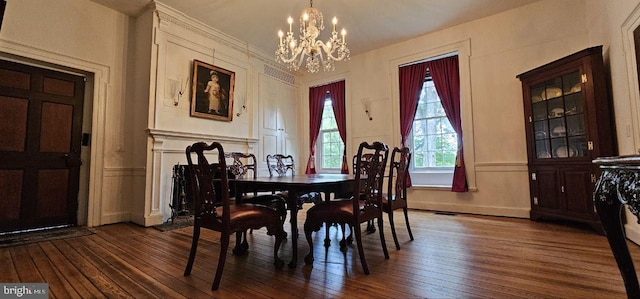 dining space with dark hardwood / wood-style floors and a chandelier