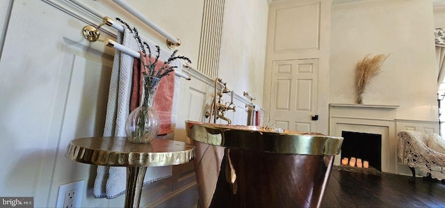 interior space featuring white cabinets, hardwood / wood-style flooring, and crown molding