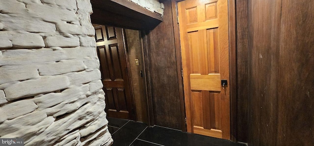 interior space featuring dark tile patterned flooring